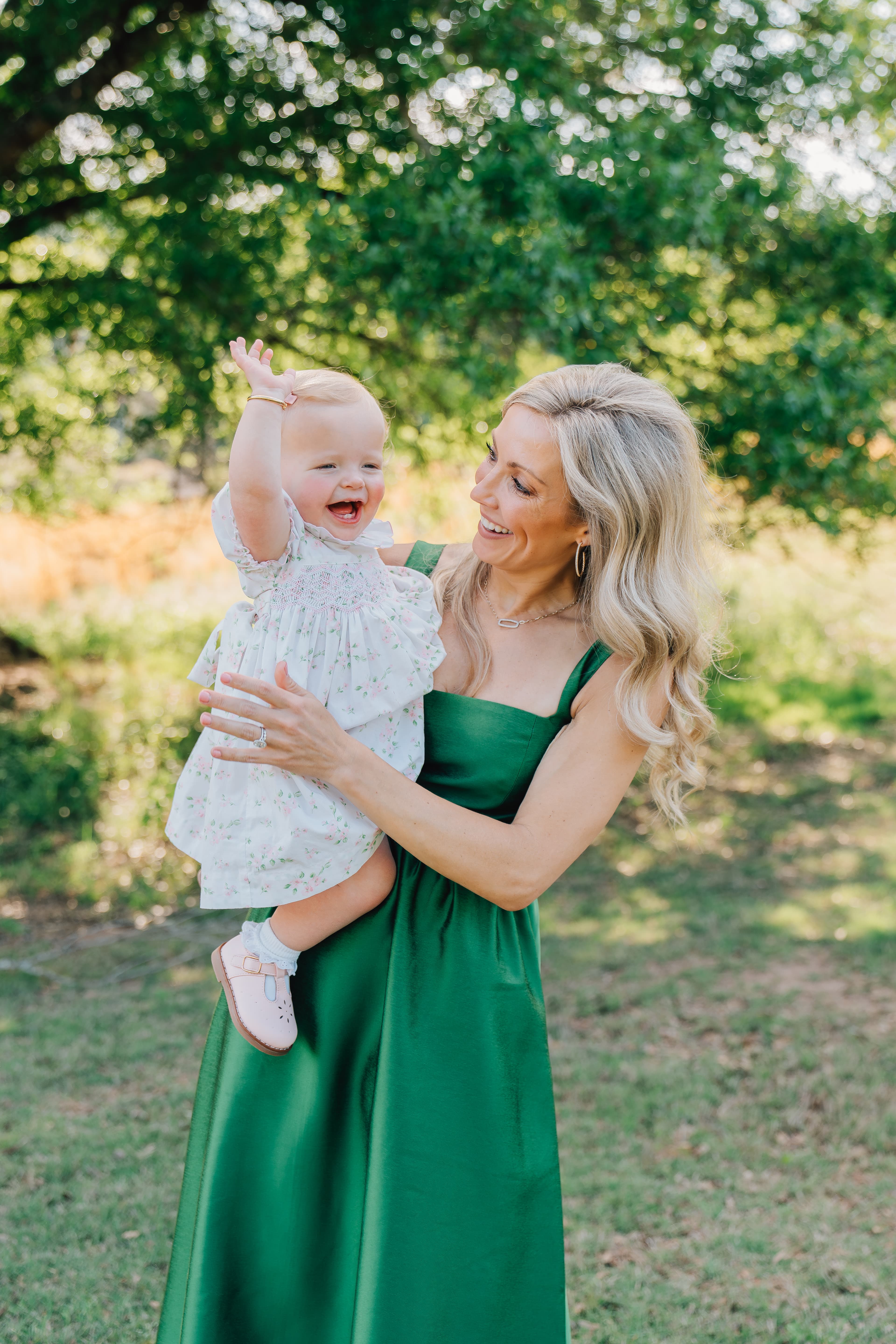 A mother laughing with her toddler outdoors, A. Bloch Photography